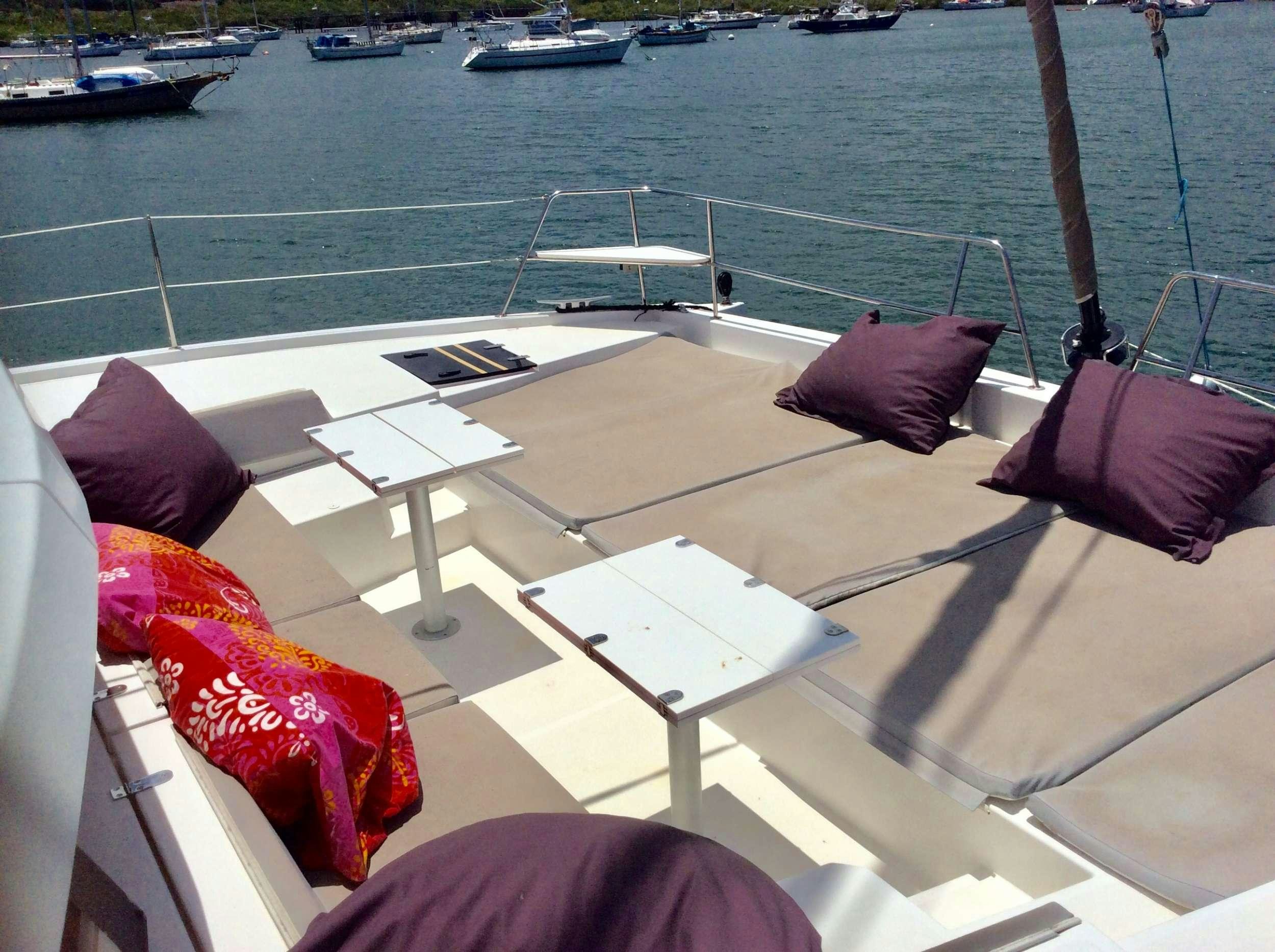 a table and chairs on a boat aboard Raiatea Yacht for Charter