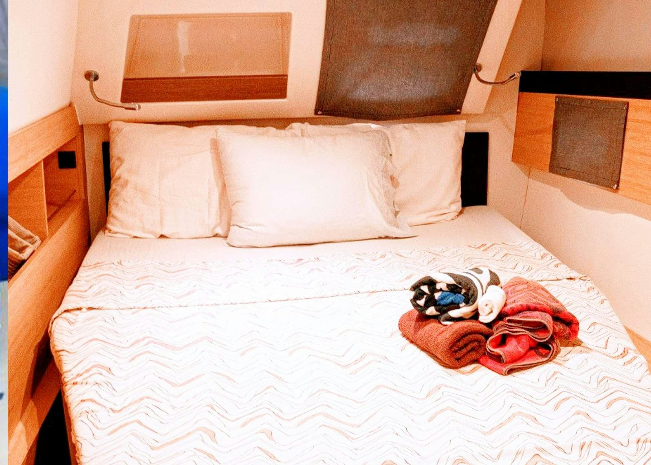 a couple of stuffed animals lay on a bed aboard Raiatea Yacht for Charter
