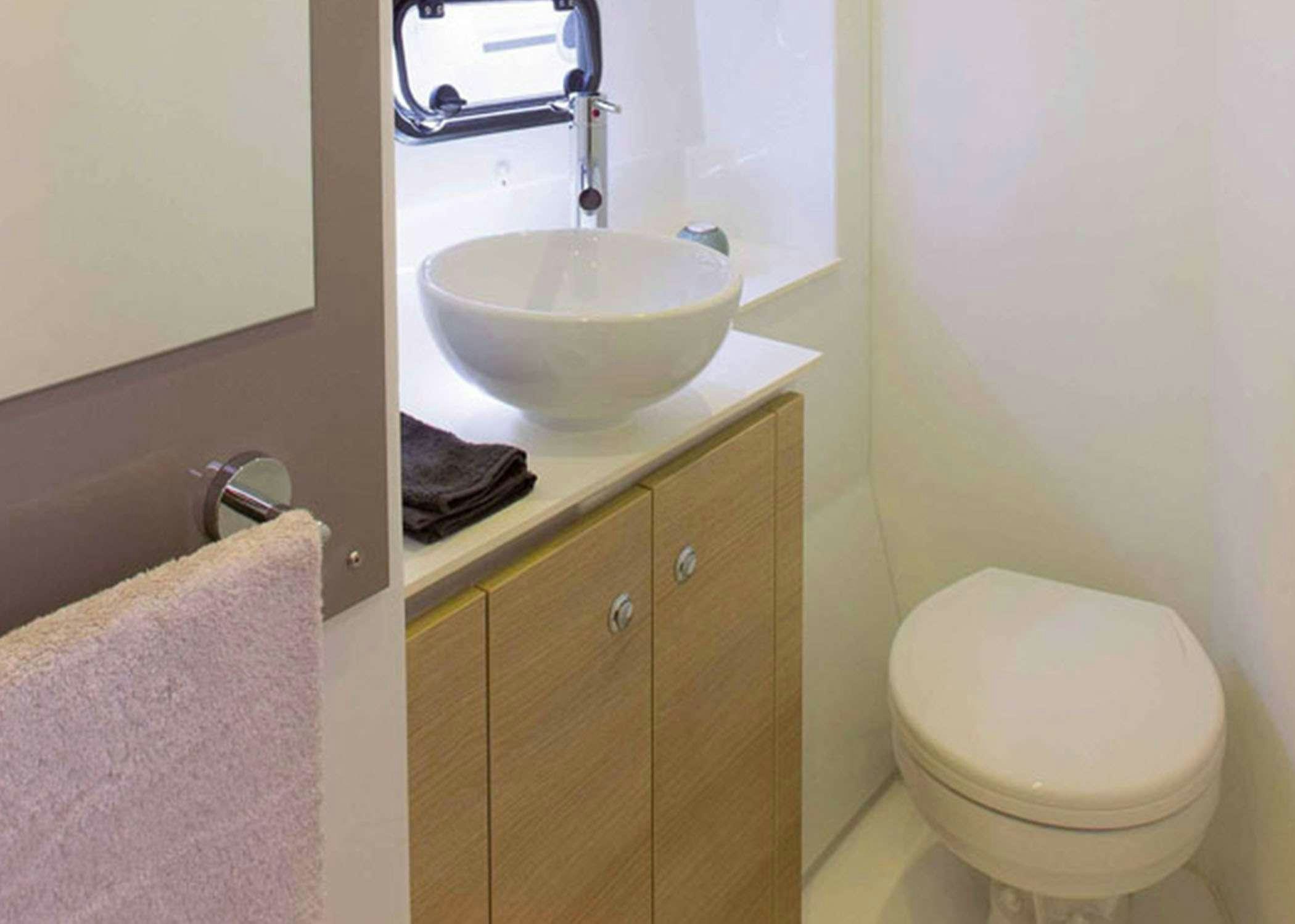 a bathroom with a sink and toilet aboard Raiatea Yacht for Charter