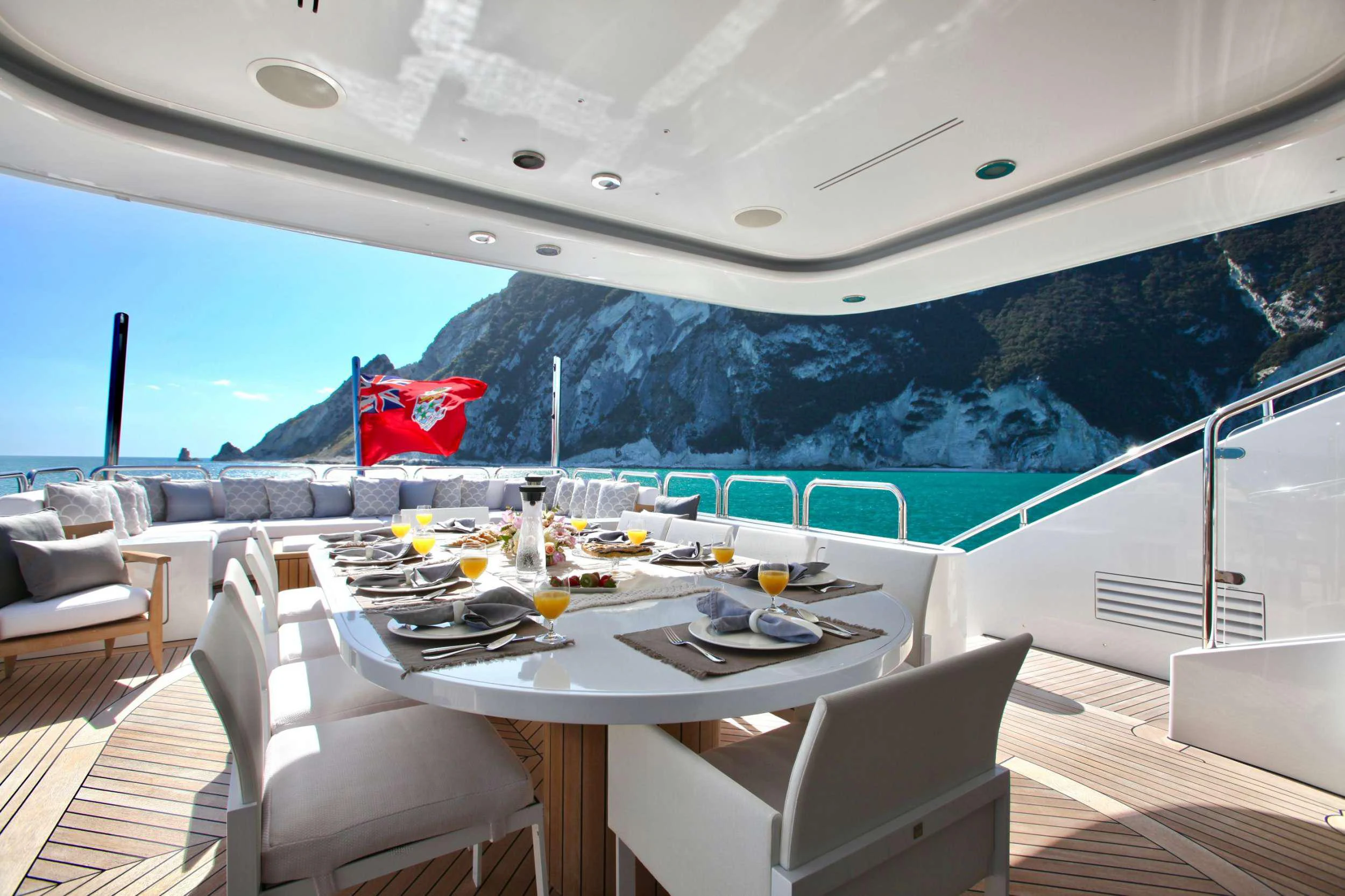 a table on a deck overlooking a large body of water aboard ALALYA Yacht for Charter