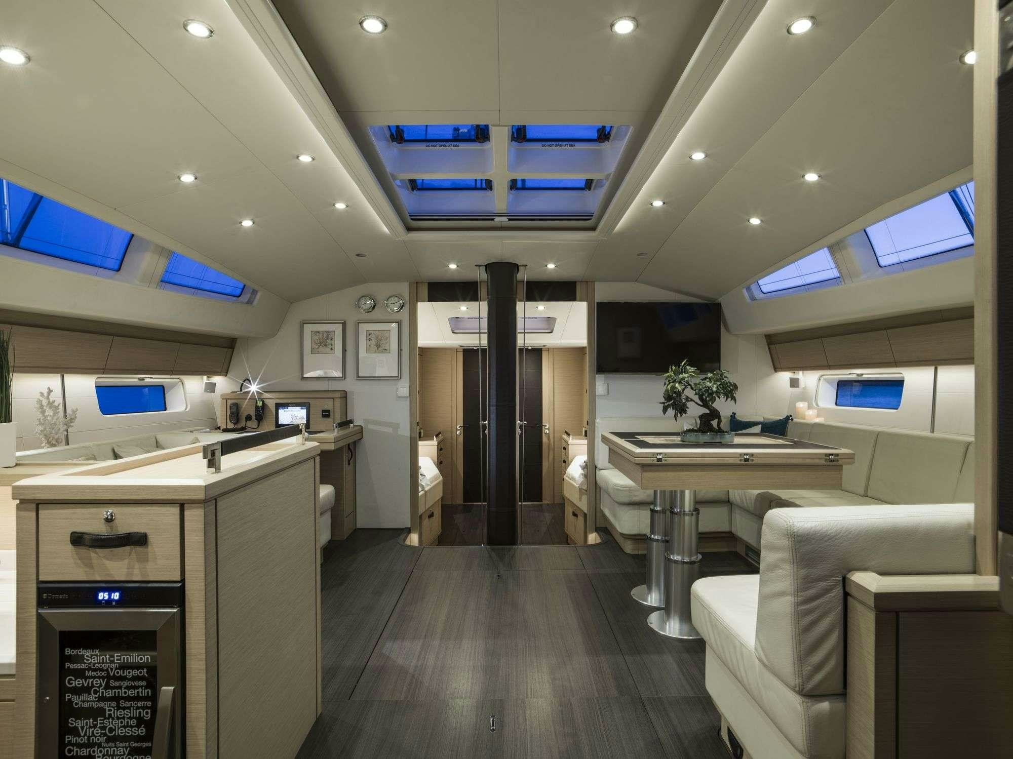 a kitchen with a table and chairs aboard THEA Yacht for Charter