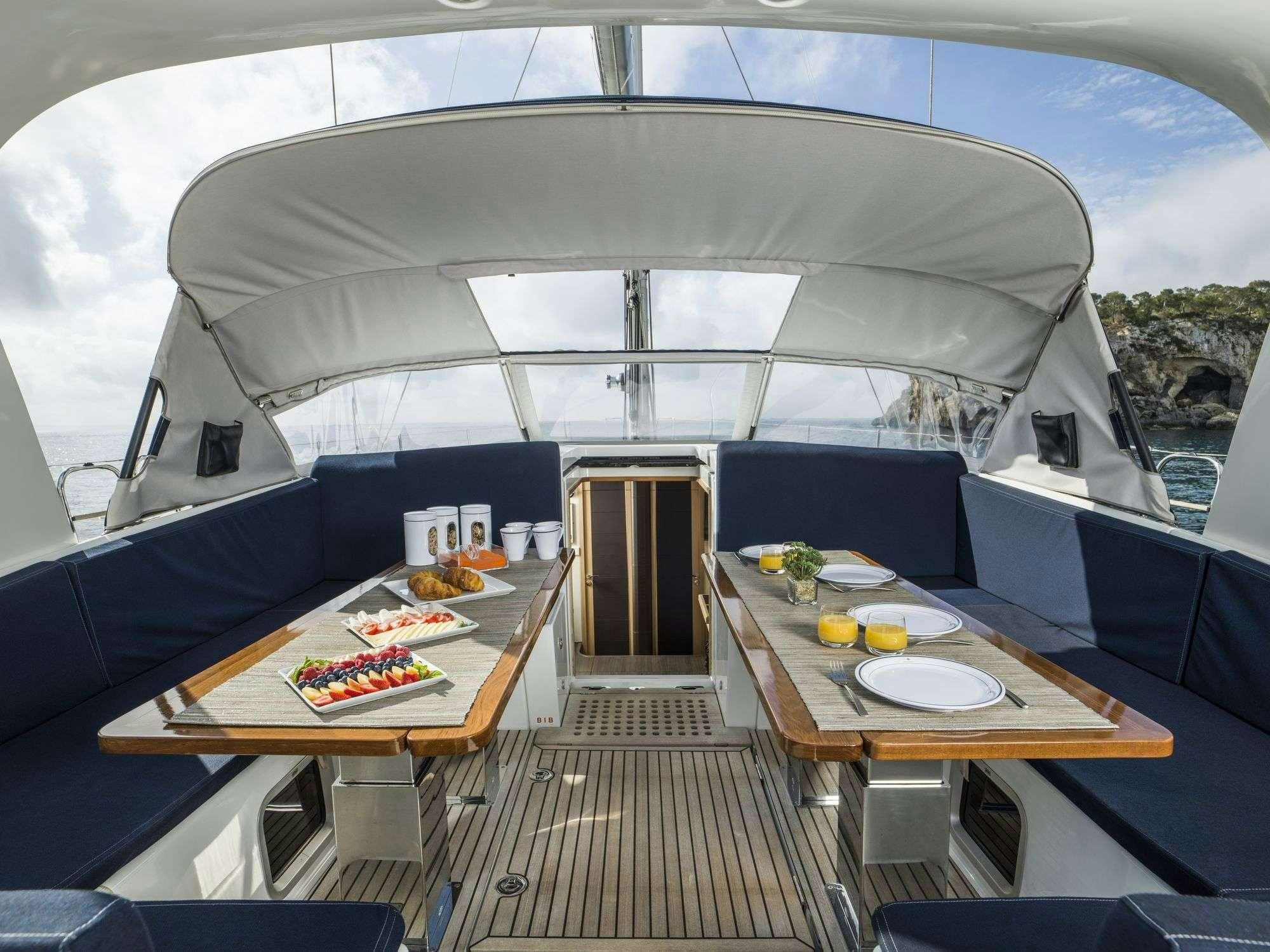 a large tent with a table and chairs aboard THEA Yacht for Charter