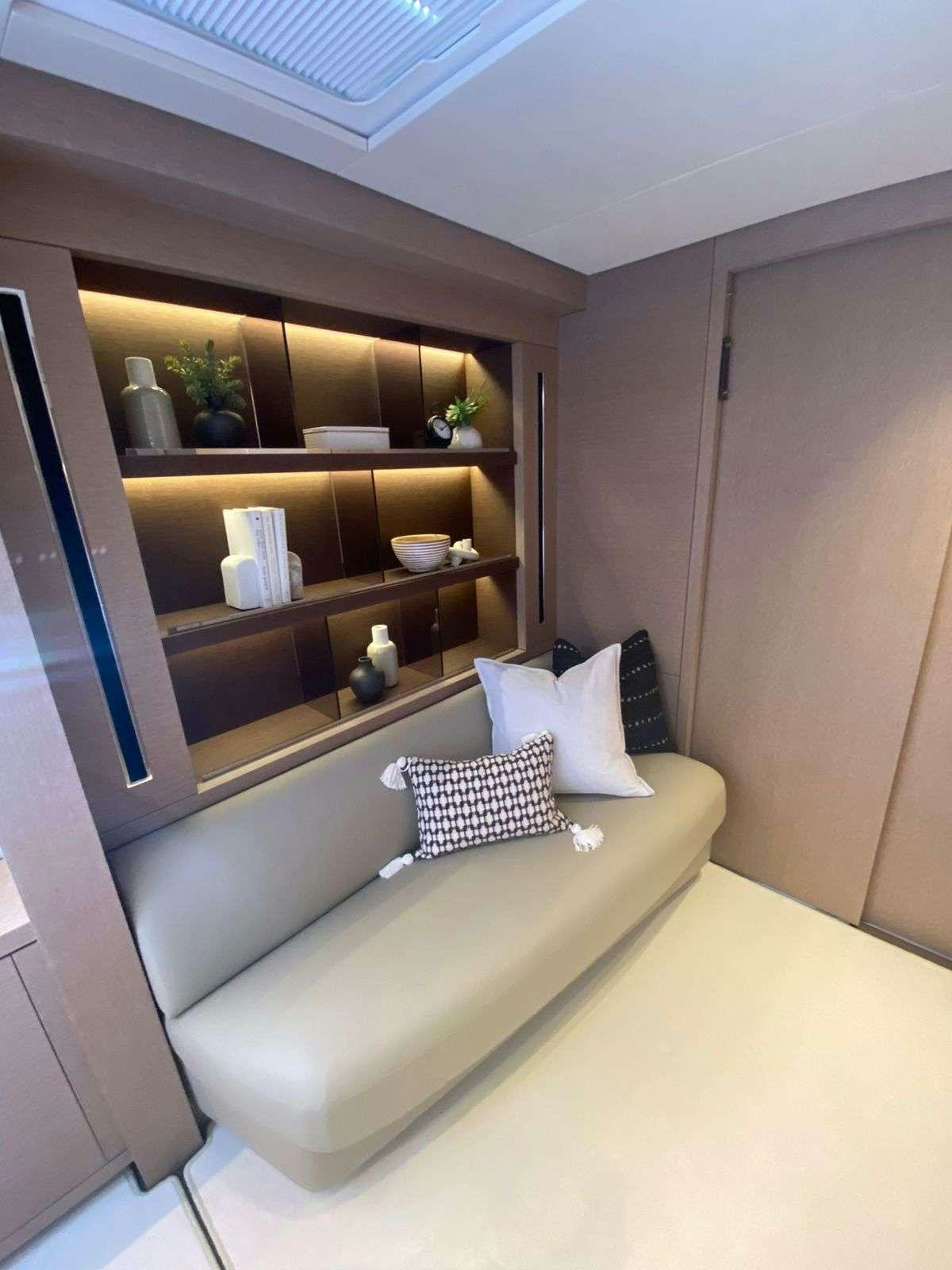 a room with a bed and shelves aboard C’EST LA VIE Yacht for Charter