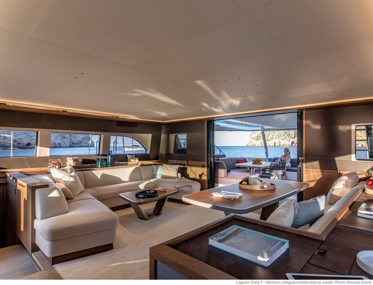 a living room with a large window aboard C’EST LA VIE Yacht for Charter