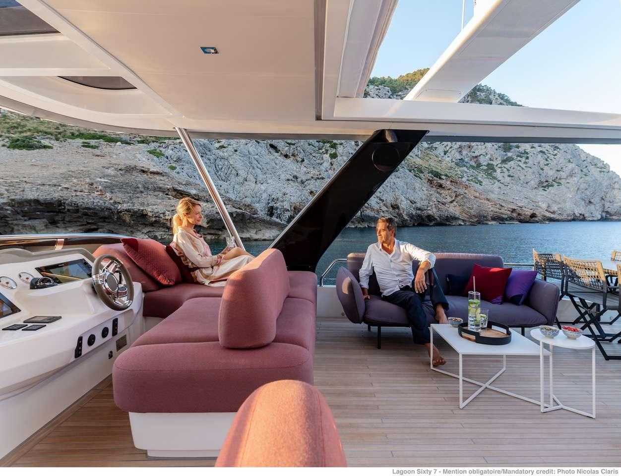 a couple sitting on a couch aboard C’EST LA VIE Yacht for Charter