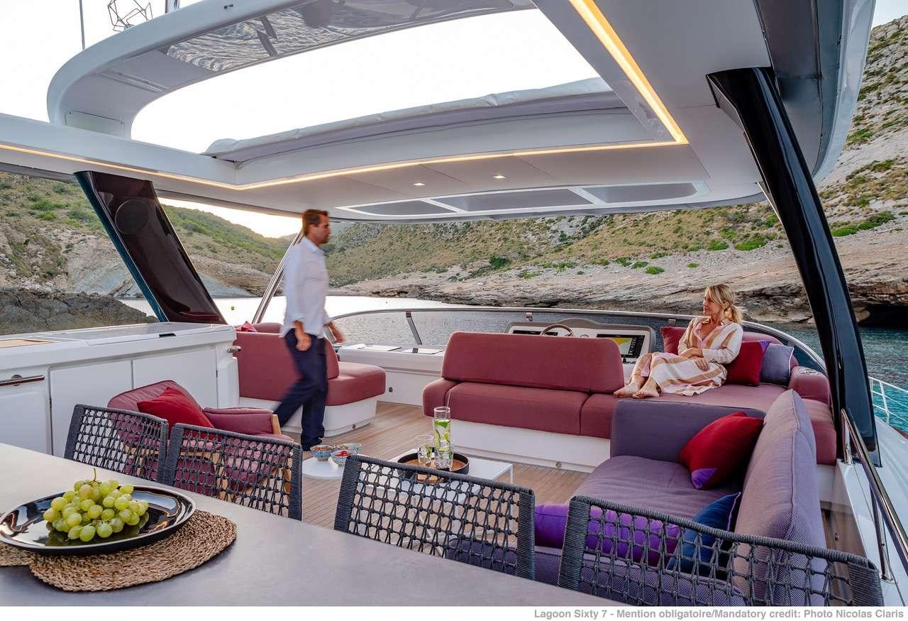 a couple of people standing in a tent aboard C’EST LA VIE Yacht for Charter