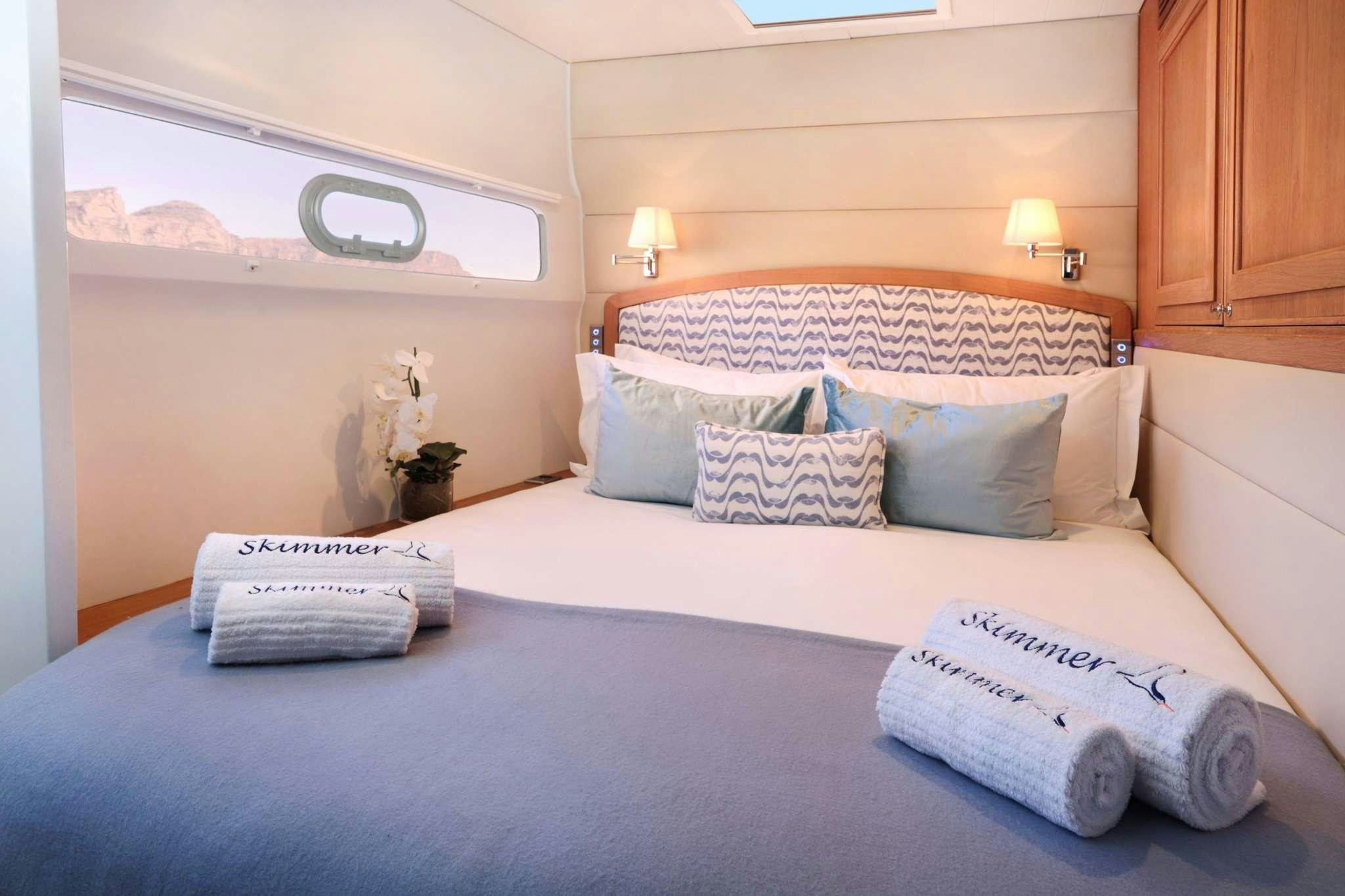 a bed with pillows and pillows aboard SKIMMER Yacht for Charter