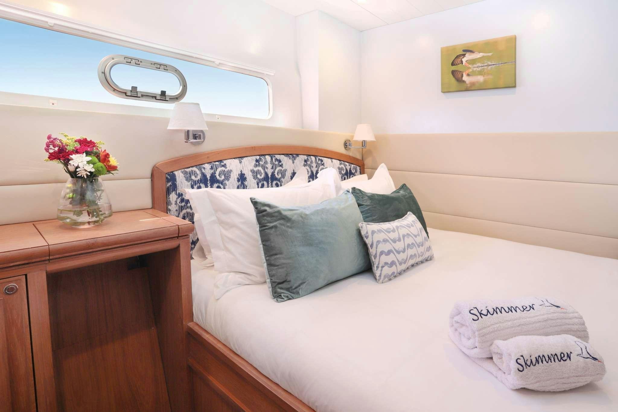 a bed with pillows and pillows aboard SKIMMER Yacht for Charter