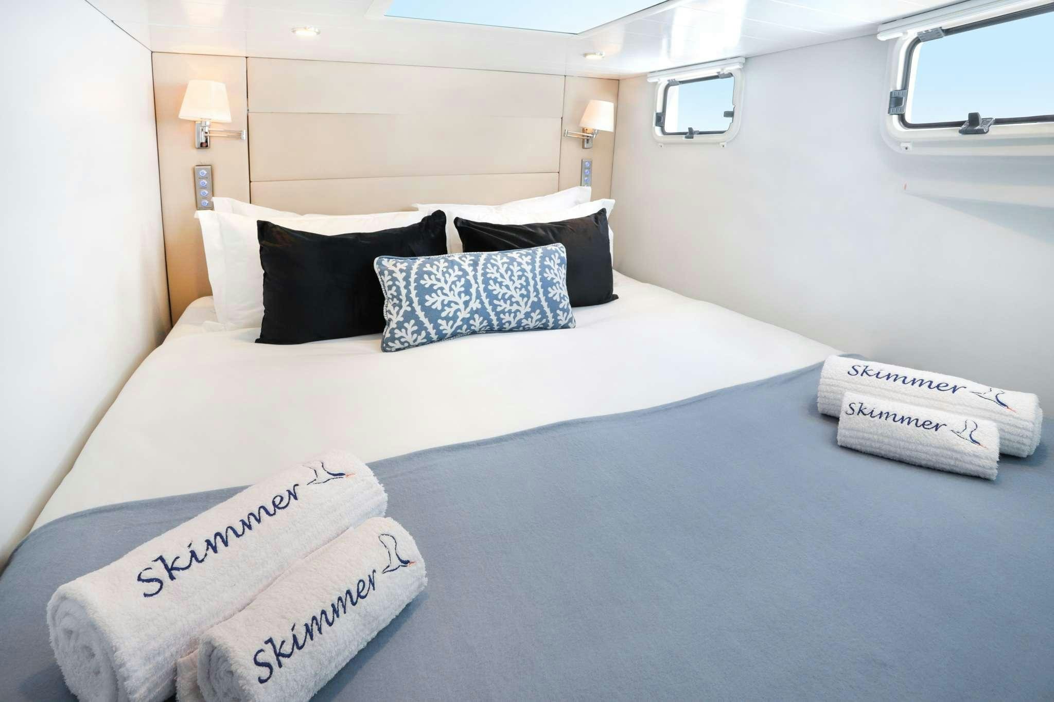 a bed with pillows and pillows aboard SKIMMER Yacht for Charter