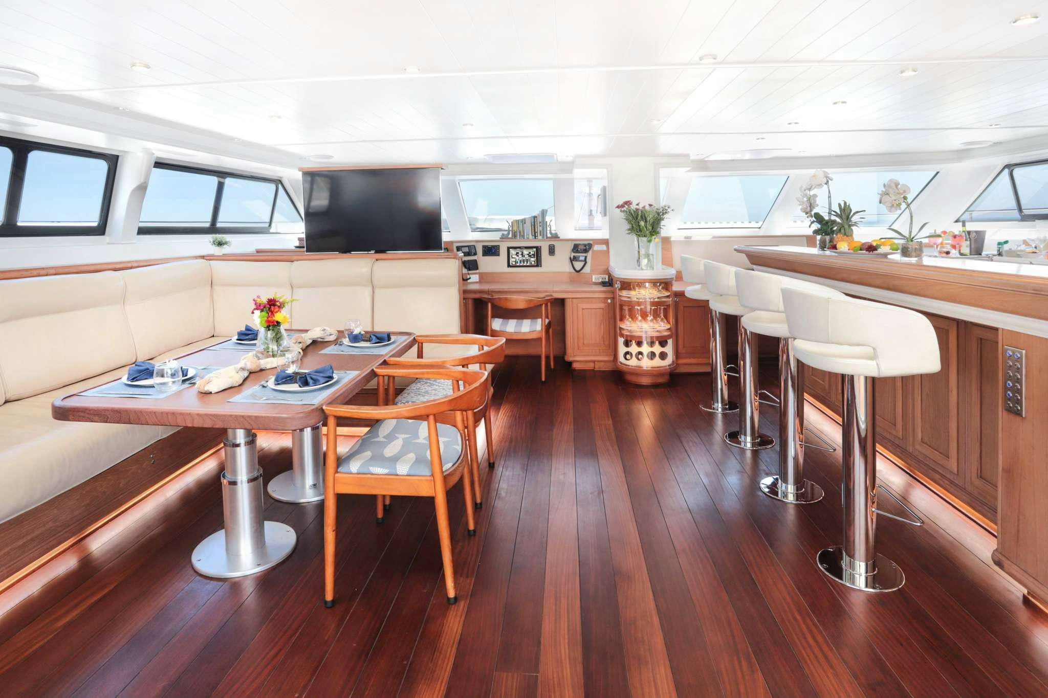 a kitchen with a table and chairs aboard SKIMMER Yacht for Charter