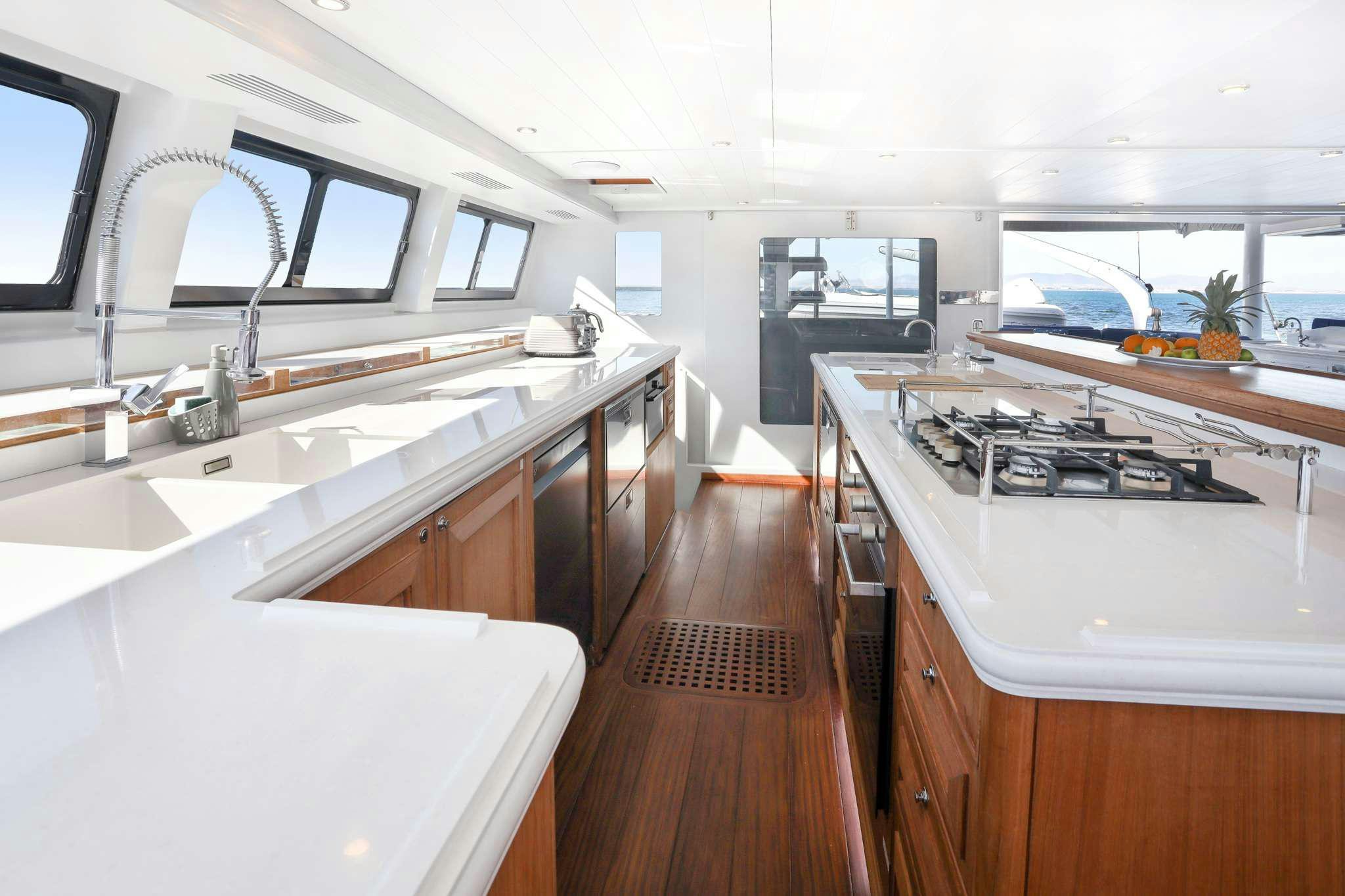 a kitchen with a large island aboard SKIMMER Yacht for Charter