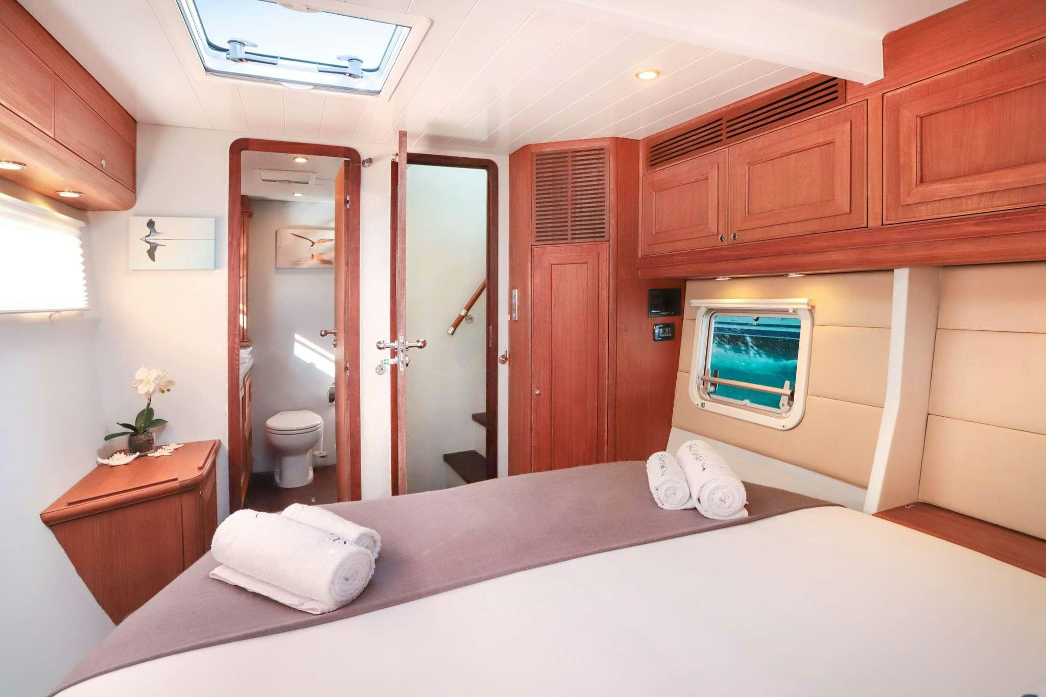 a bedroom with a bed and a desk aboard SKIMMER Yacht for Charter