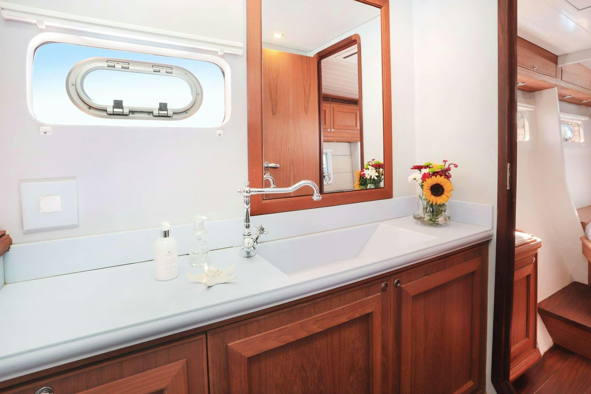 a bathroom with a large mirror aboard SKIMMER Yacht for Charter