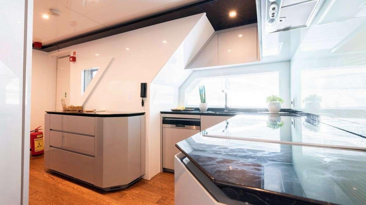 a kitchen with a large island aboard LADY CAROLINE Yacht for Charter