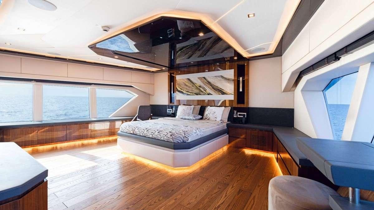 a room with a bed and a window aboard LADY CAROLINE Yacht for Charter