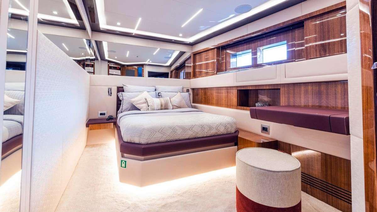 a room with a bed and a table aboard LADY CAROLINE Yacht for Charter