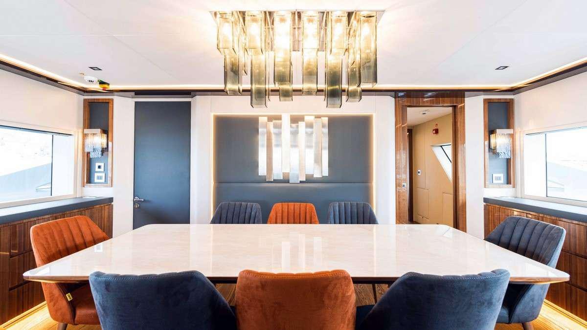 a dining table in a room aboard LADY CAROLINE Yacht for Charter