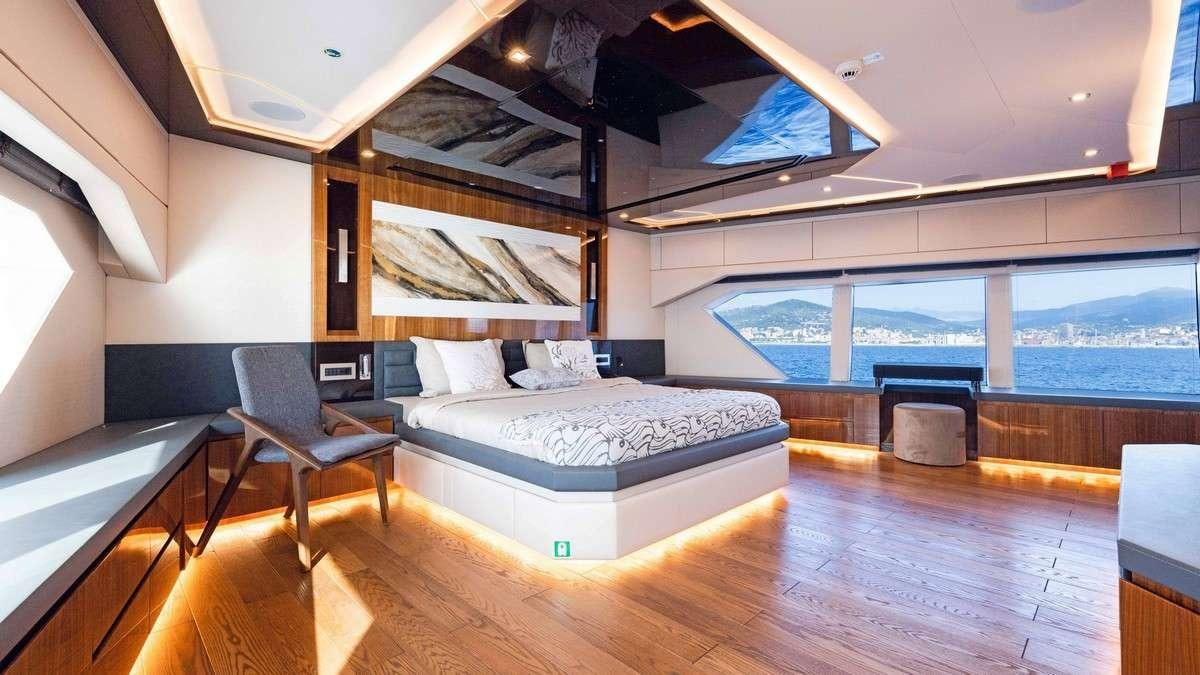 a bedroom with a large bed aboard LADY CAROLINE Yacht for Charter