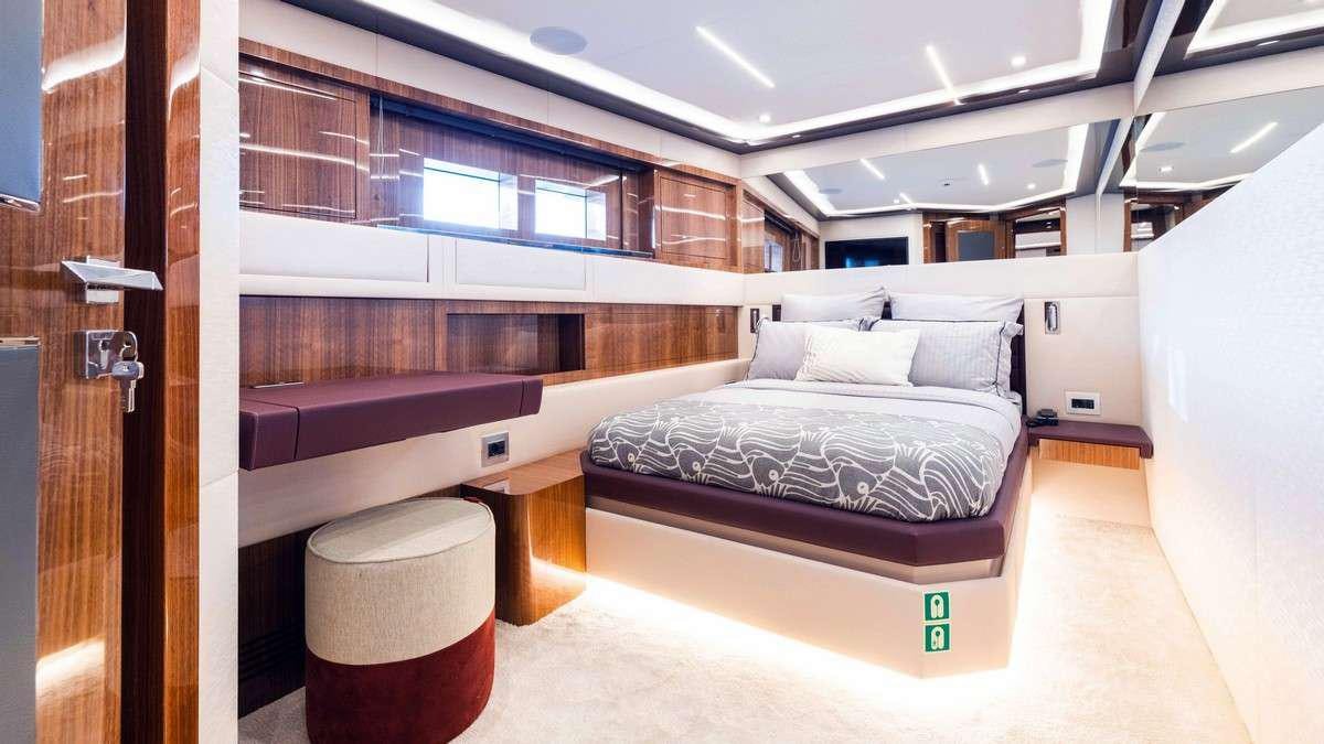 a room with a bed and a desk aboard LADY CAROLINE Yacht for Charter