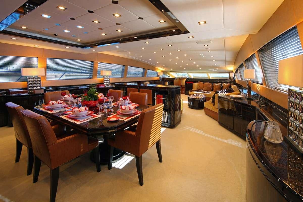 a large room with a table and chairs aboard HARMONIC WAVES Yacht for Charter