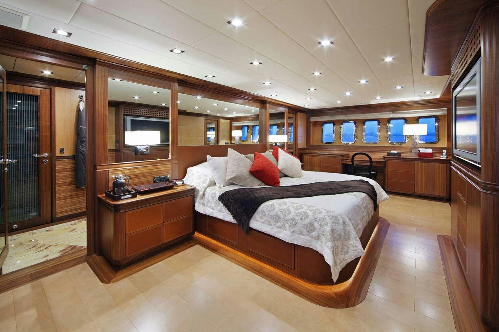 a room with a bed and a tv aboard HARMONIC WAVES Yacht for Charter