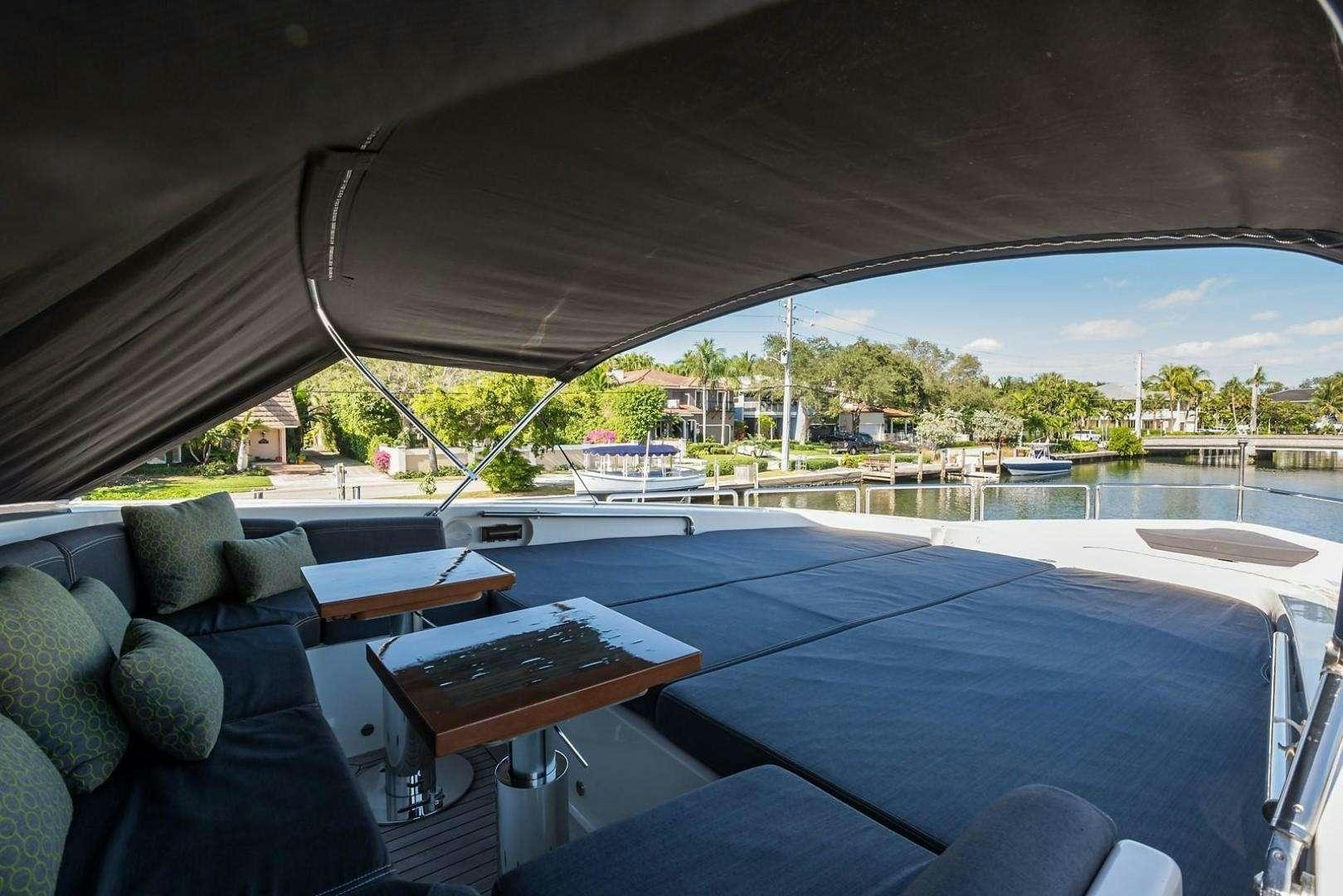 a large patio with a pool and a view of the water aboard ENCORE Yacht for Charter