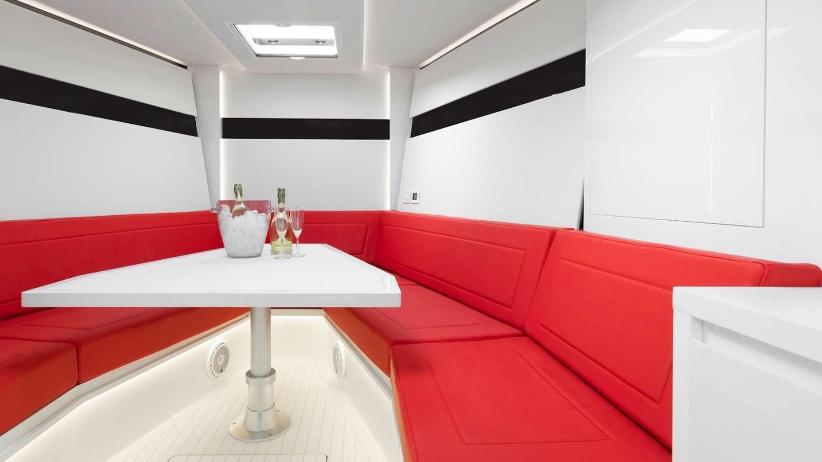 a red couch in a room aboard 48 Van Dutch  Yacht for Charter