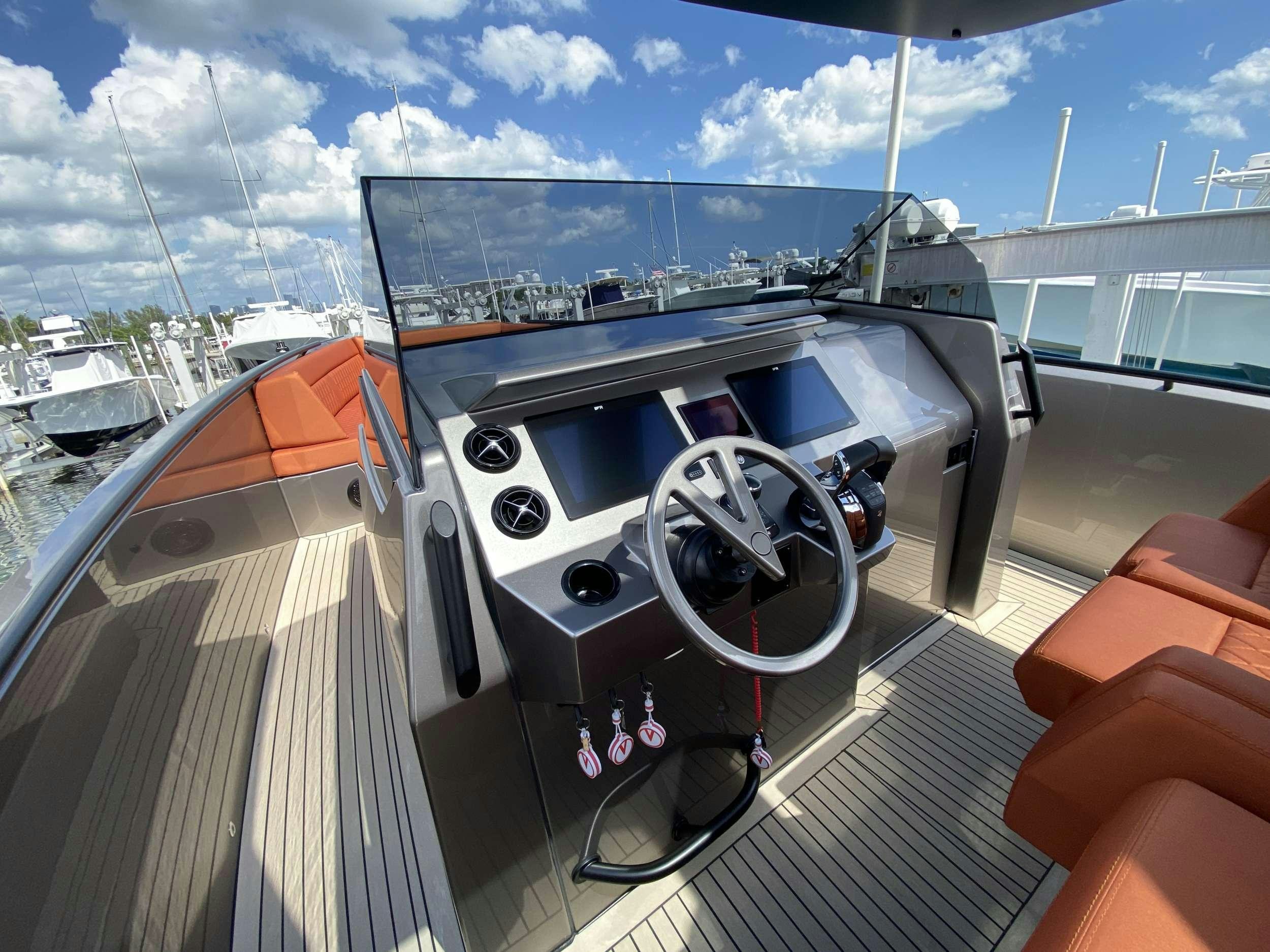 a hand holding a steering wheel on a boat aboard Money Penny  Yacht for Charter