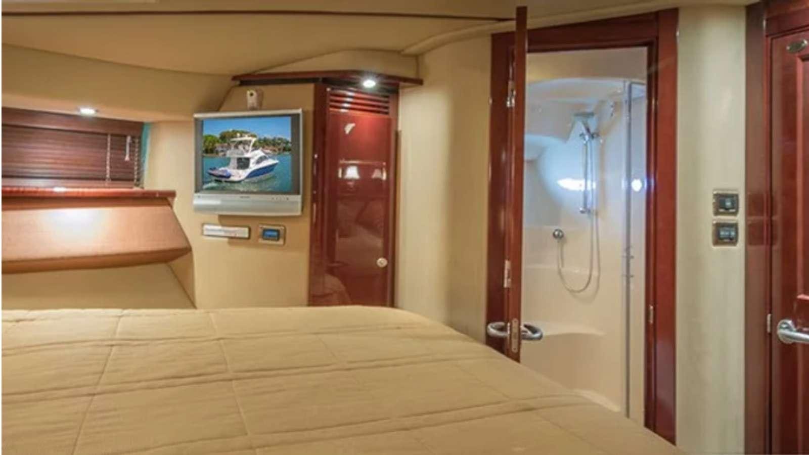 a hotel room with a bed and a door aboard Champagne  Yacht for Charter