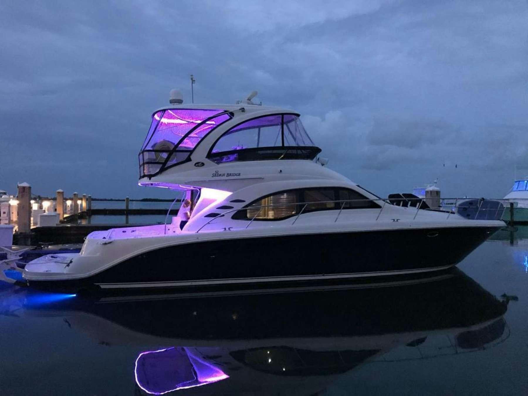 a white yacht in a harbor aboard Champagne  Yacht for Charter