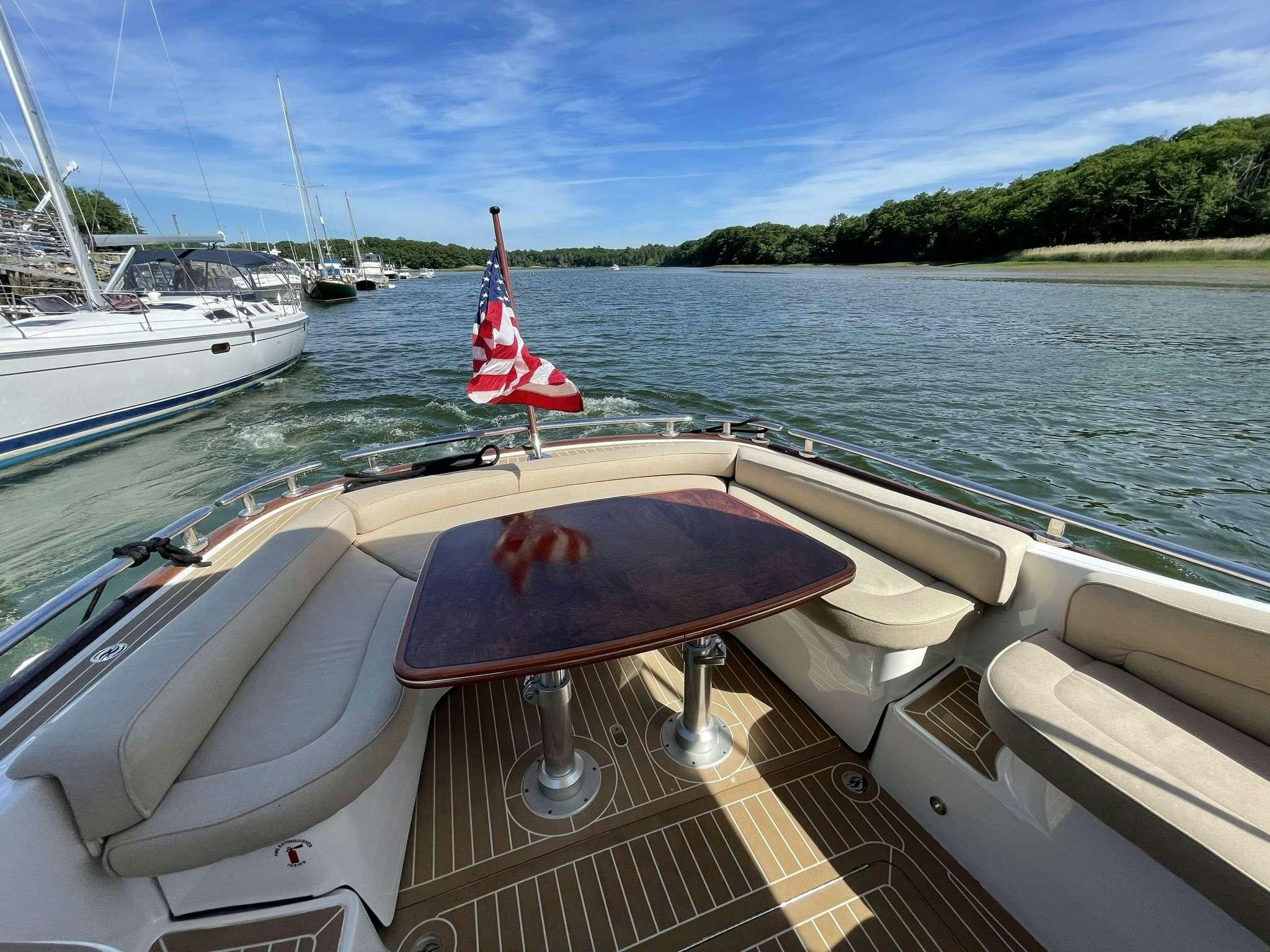 a boat with a sail on the water aboard GUCCI Yacht for Charter