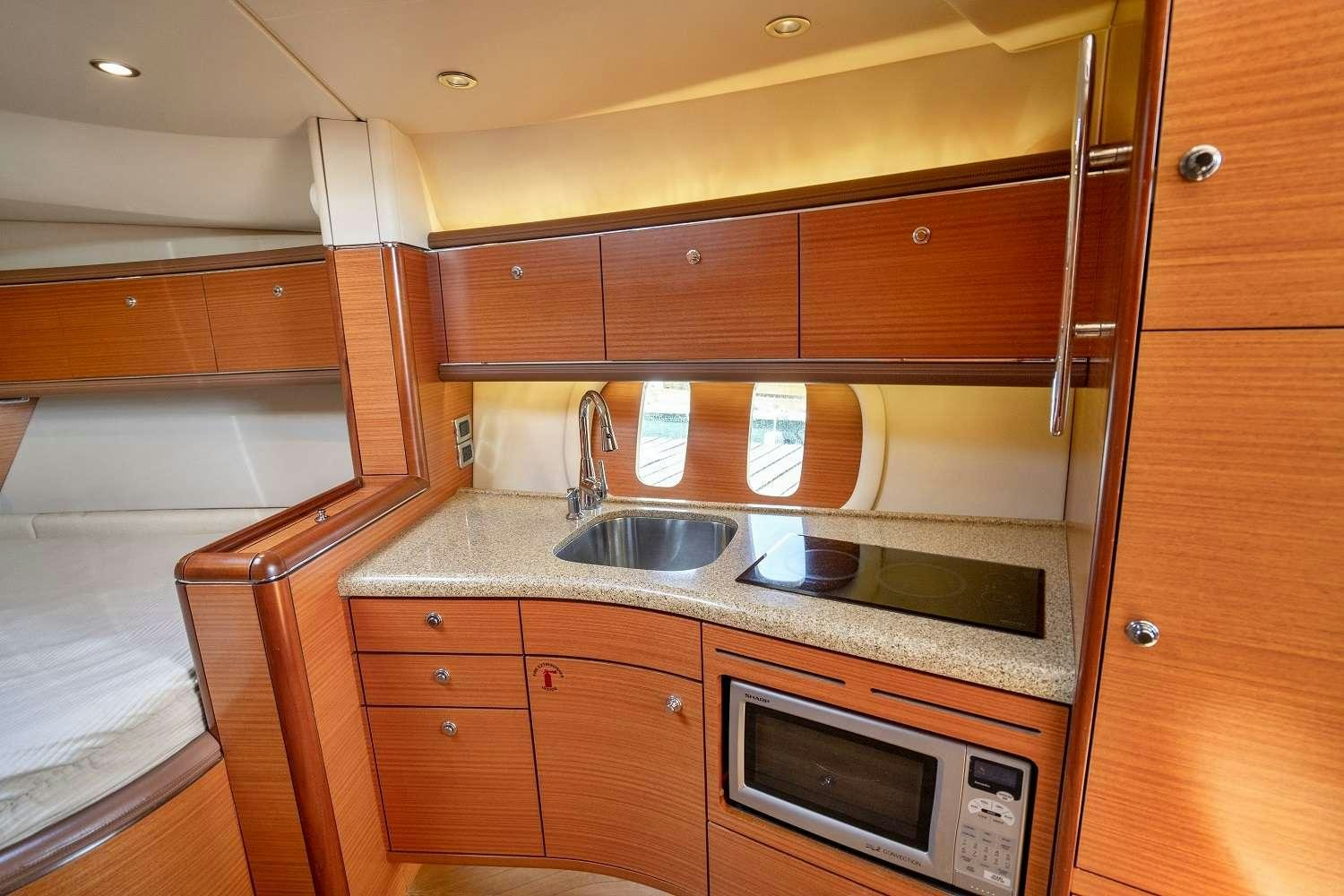 a kitchen with wooden cabinets aboard GUCCI Yacht for Charter