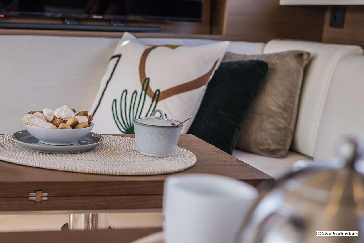 a white mug on a table aboard MAOYA Yacht for Charter