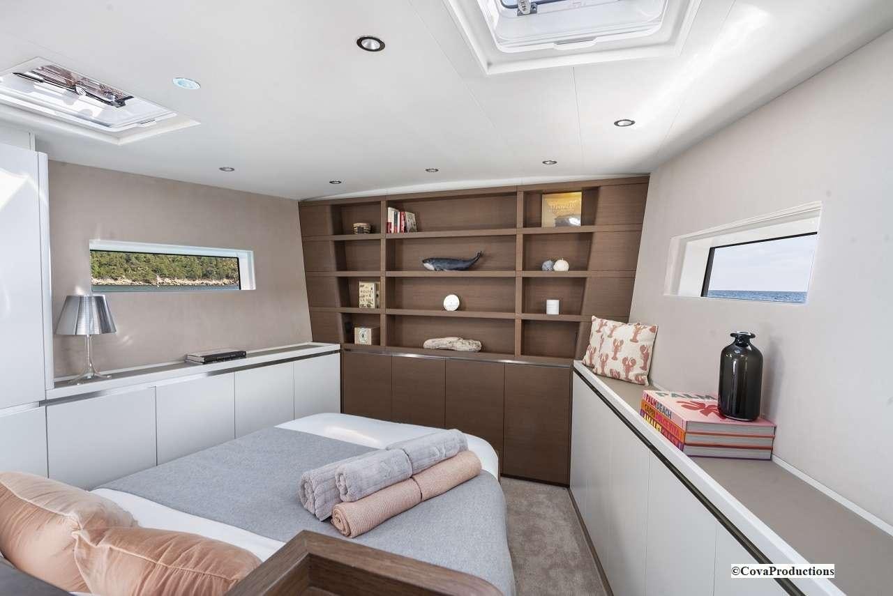 a room with a bed and a shelf aboard MAOYA Yacht for Charter