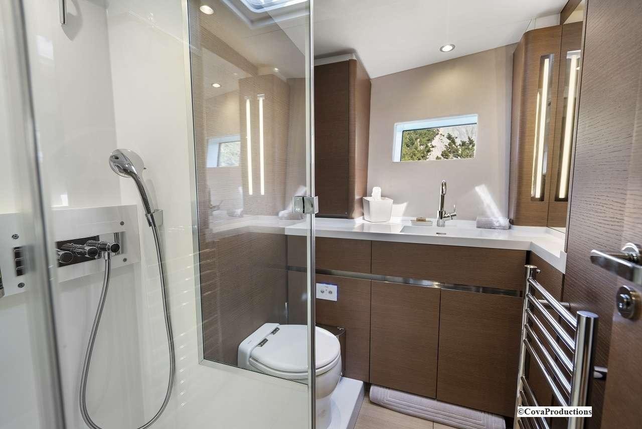 a bathroom with a glass shower aboard MAOYA Yacht for Charter