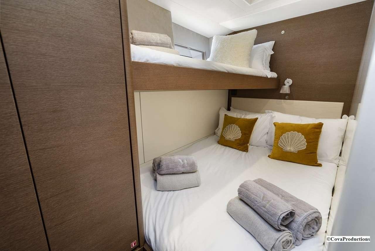 a bed with pillows and a shelf aboard MAOYA Yacht for Charter