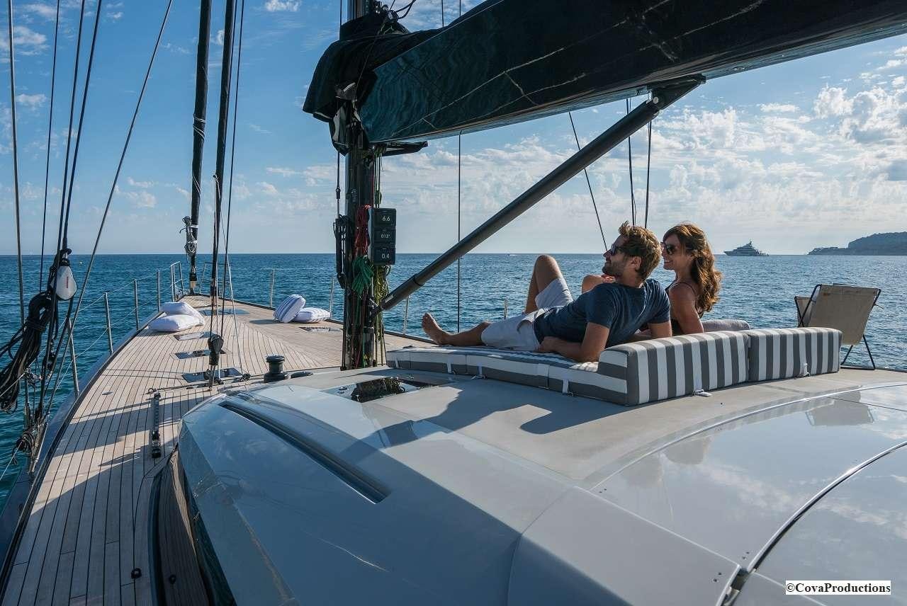 a man and woman sitting on a boat aboard MAOYA Yacht for Charter