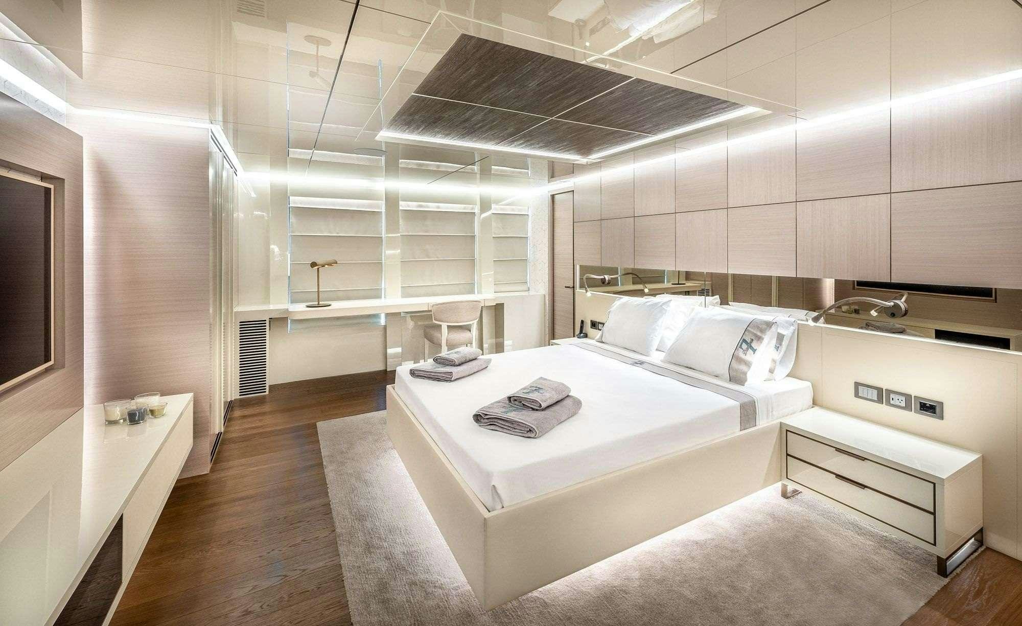 a room with a bed and a desk aboard ZARANIA Yacht for Charter