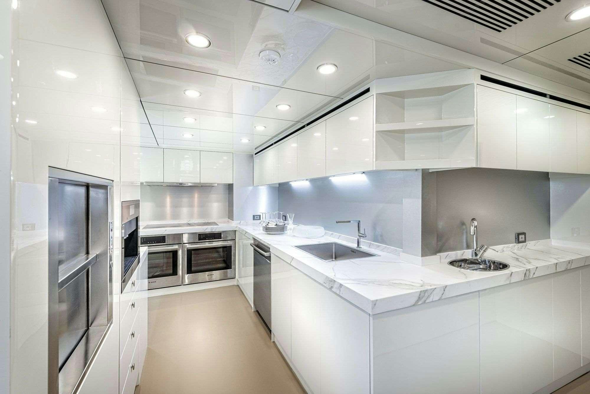 a kitchen with white cabinets aboard ZARANIA Yacht for Charter