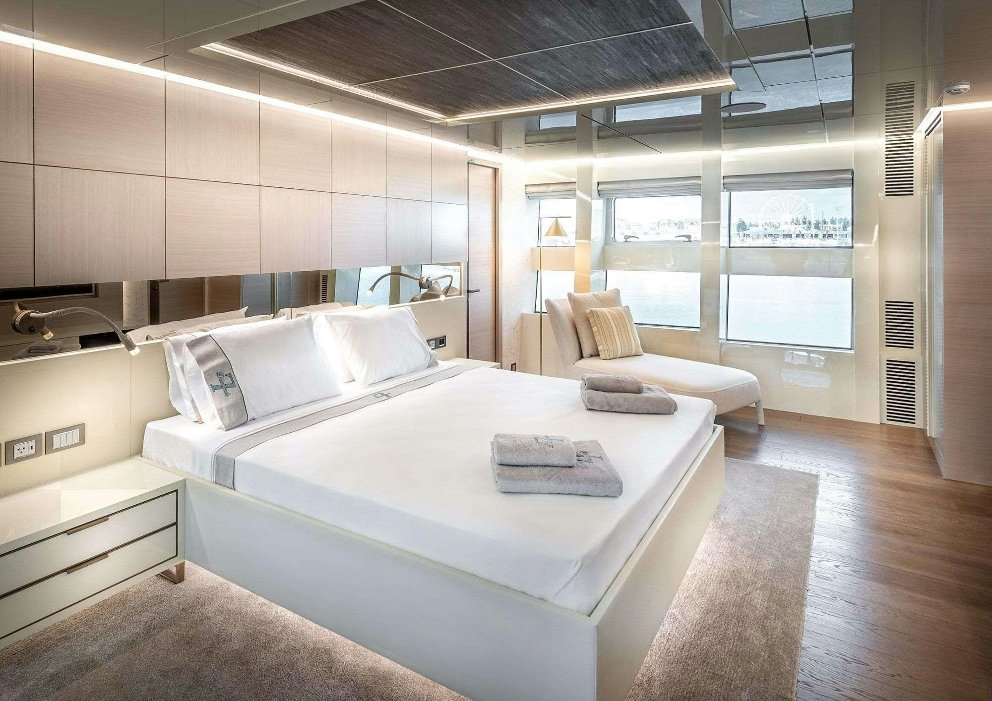 a room with a bed and a desk aboard ZARANIA Yacht for Charter