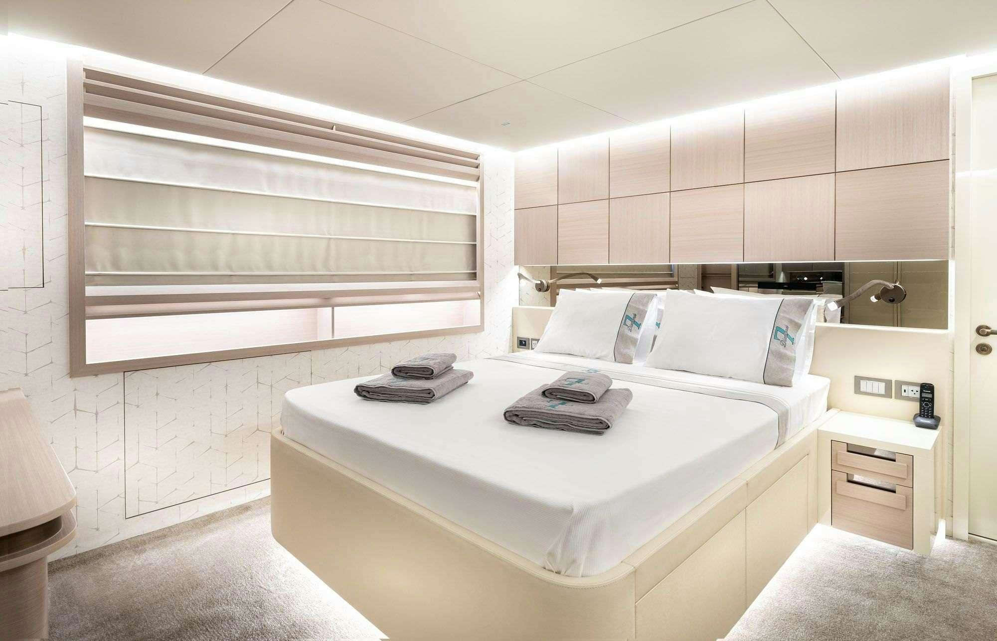 a room with a bed and a desk aboard ZARANIA Yacht for Charter