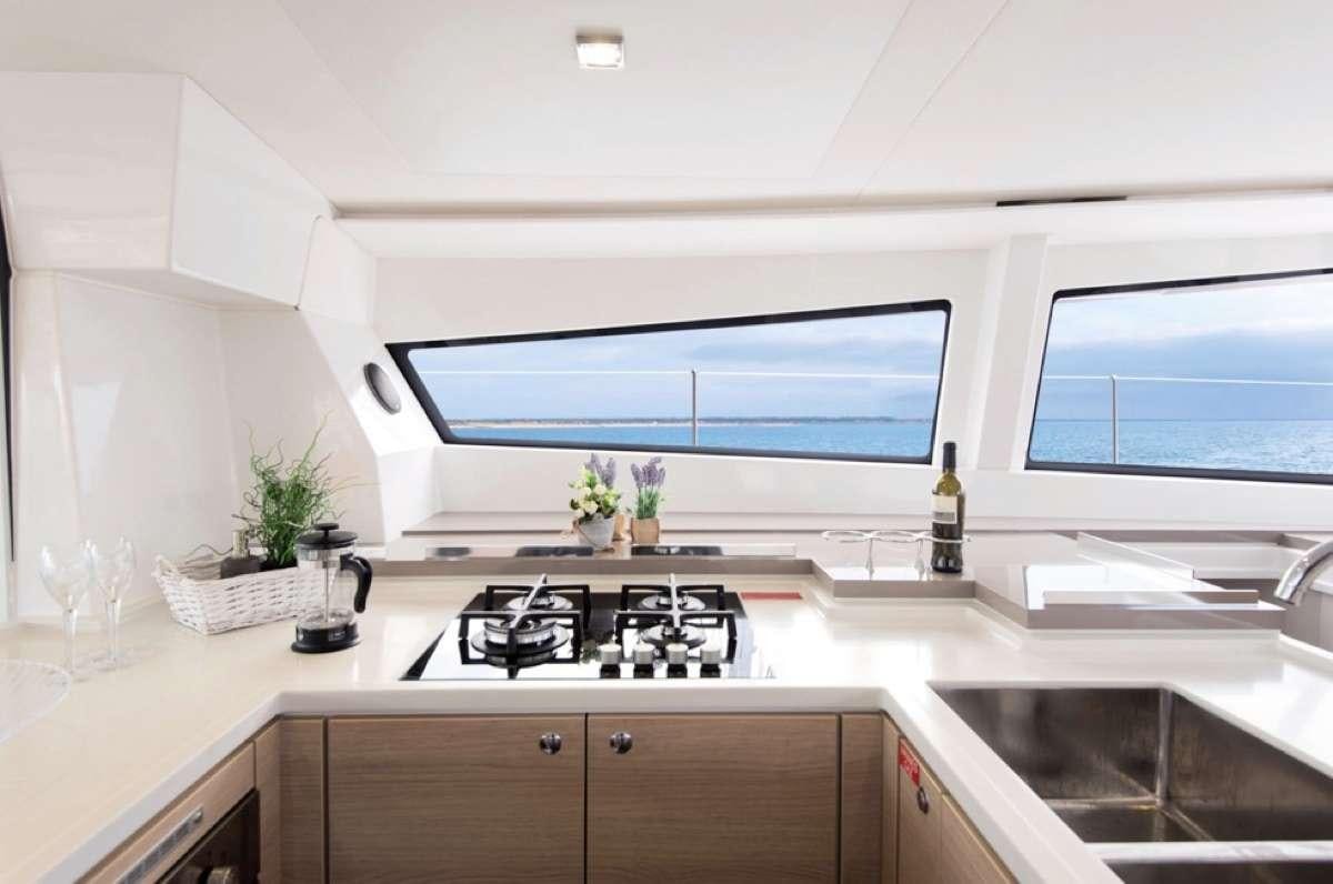 a kitchen with a large window aboard ATREYU Yacht for Charter