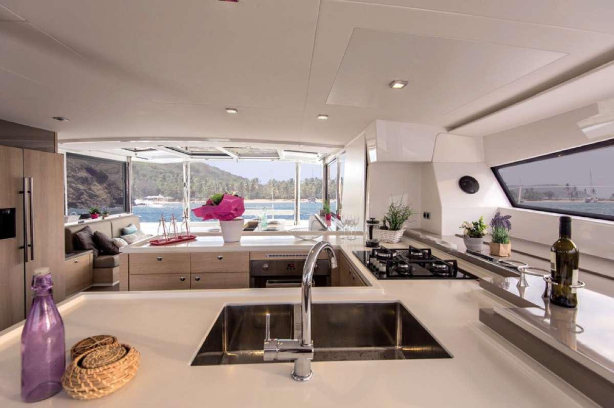 a kitchen with a large window aboard ATREYU Yacht for Charter