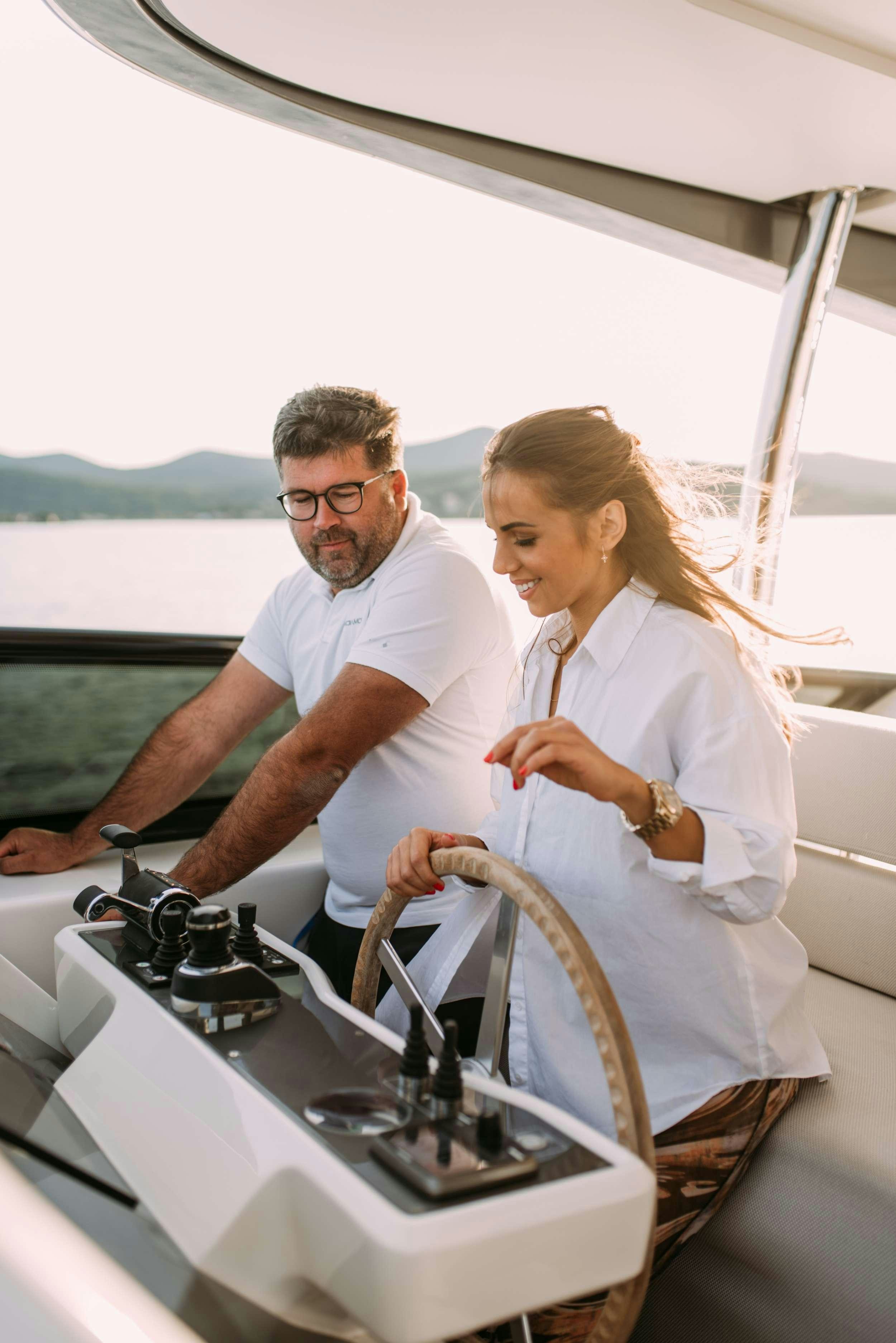 a man and woman in a boat aboard ANDIAMO Yacht for Charter