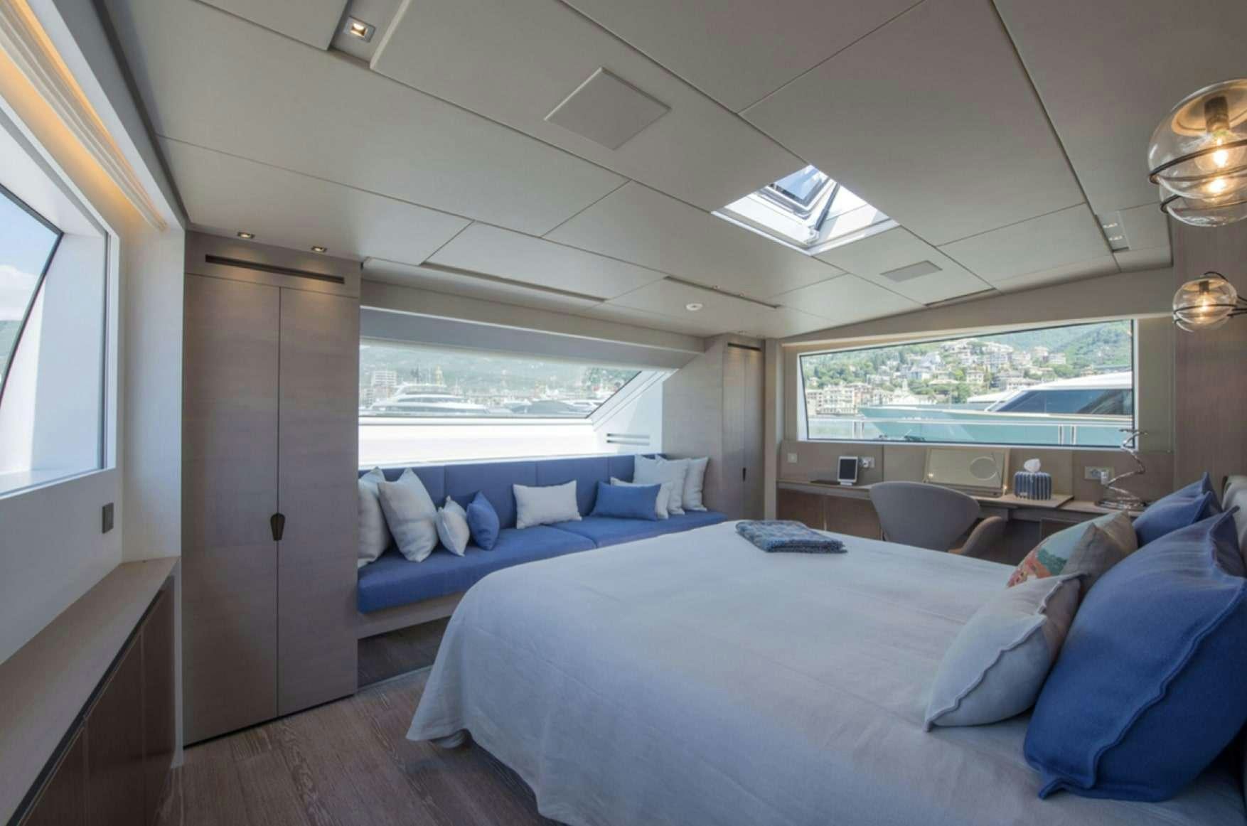 a room with a bed and a window aboard ANDIAMO Yacht for Charter