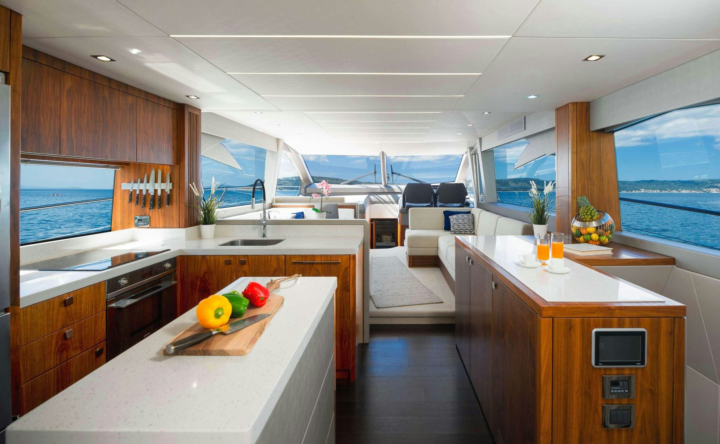 a modern kitchen with a large window aboard HIDEAWAY Yacht for Charter