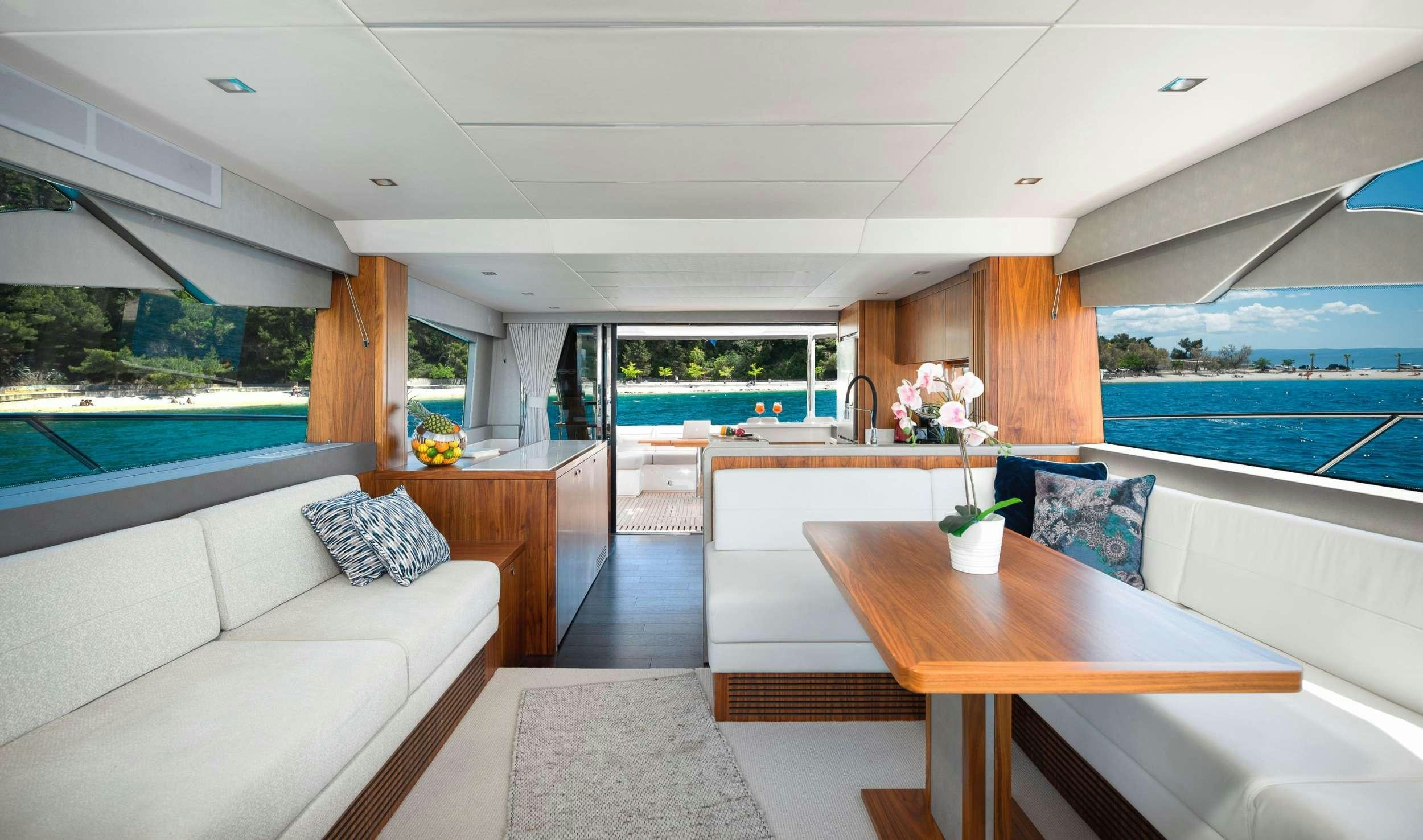 a living room with a large window aboard HIDEAWAY Yacht for Charter