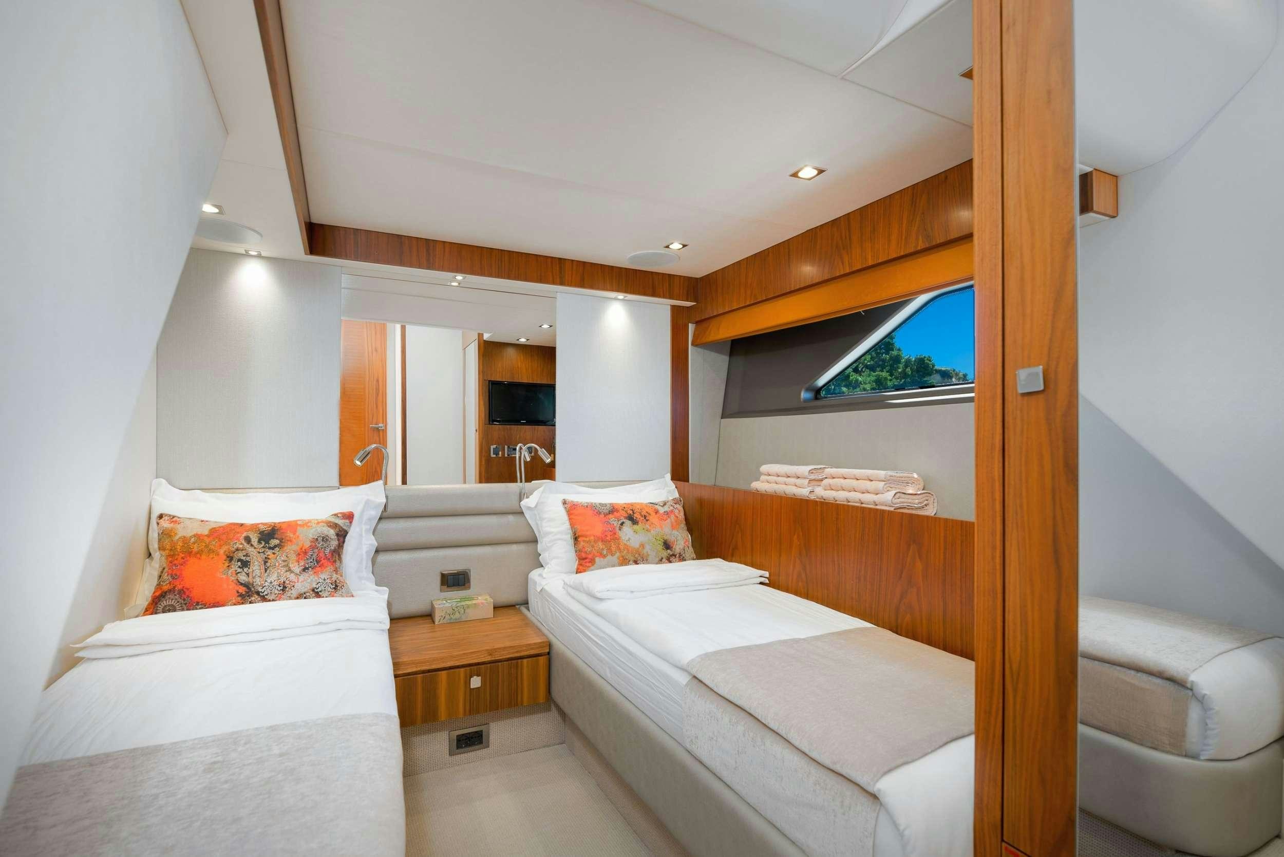a room with a bed and a window aboard HIDEAWAY Yacht for Charter