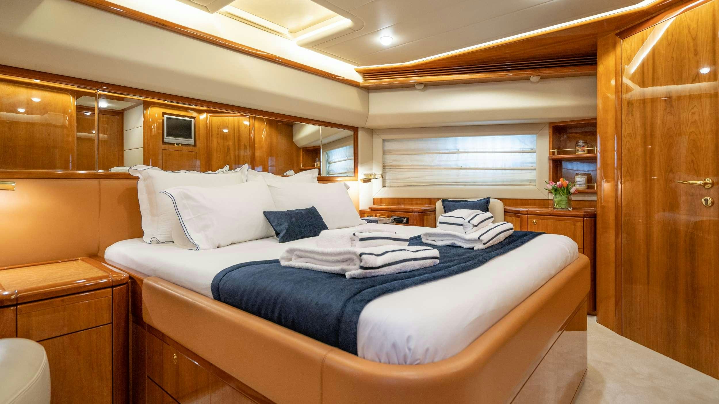 a room with a bed and a wood door aboard ESTIA YI Yacht for Charter