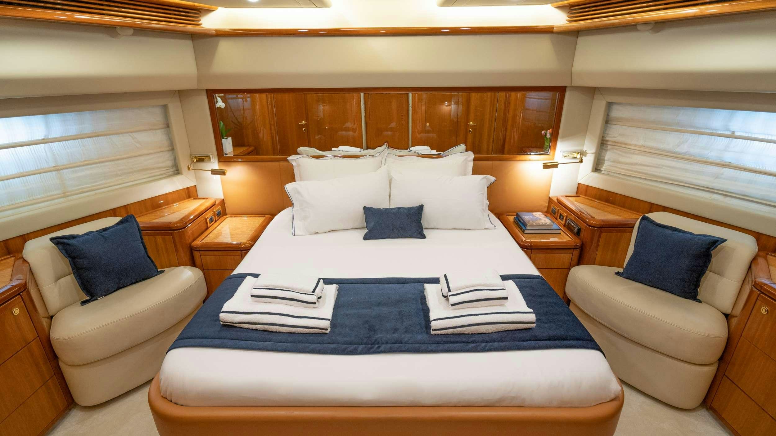 a hotel room with a bed and a couch aboard ESTIA YI Yacht for Charter